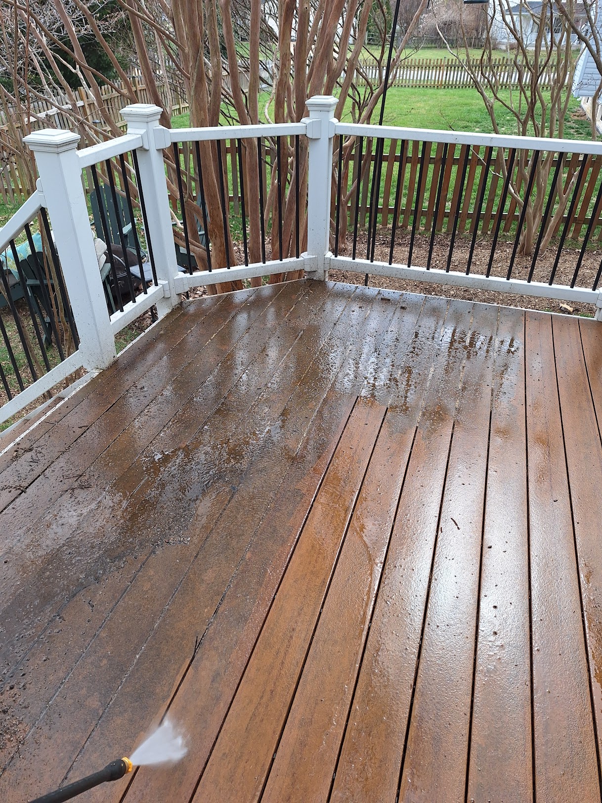 Weathered backyard deck before power washing and staining