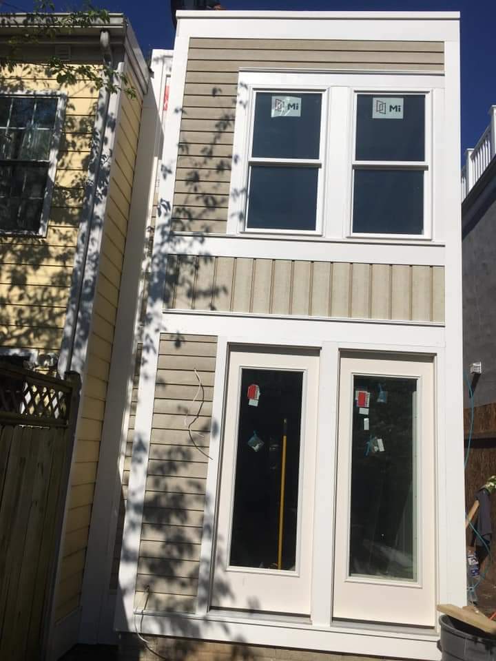 Finished two-story rear addition with new siding and windows