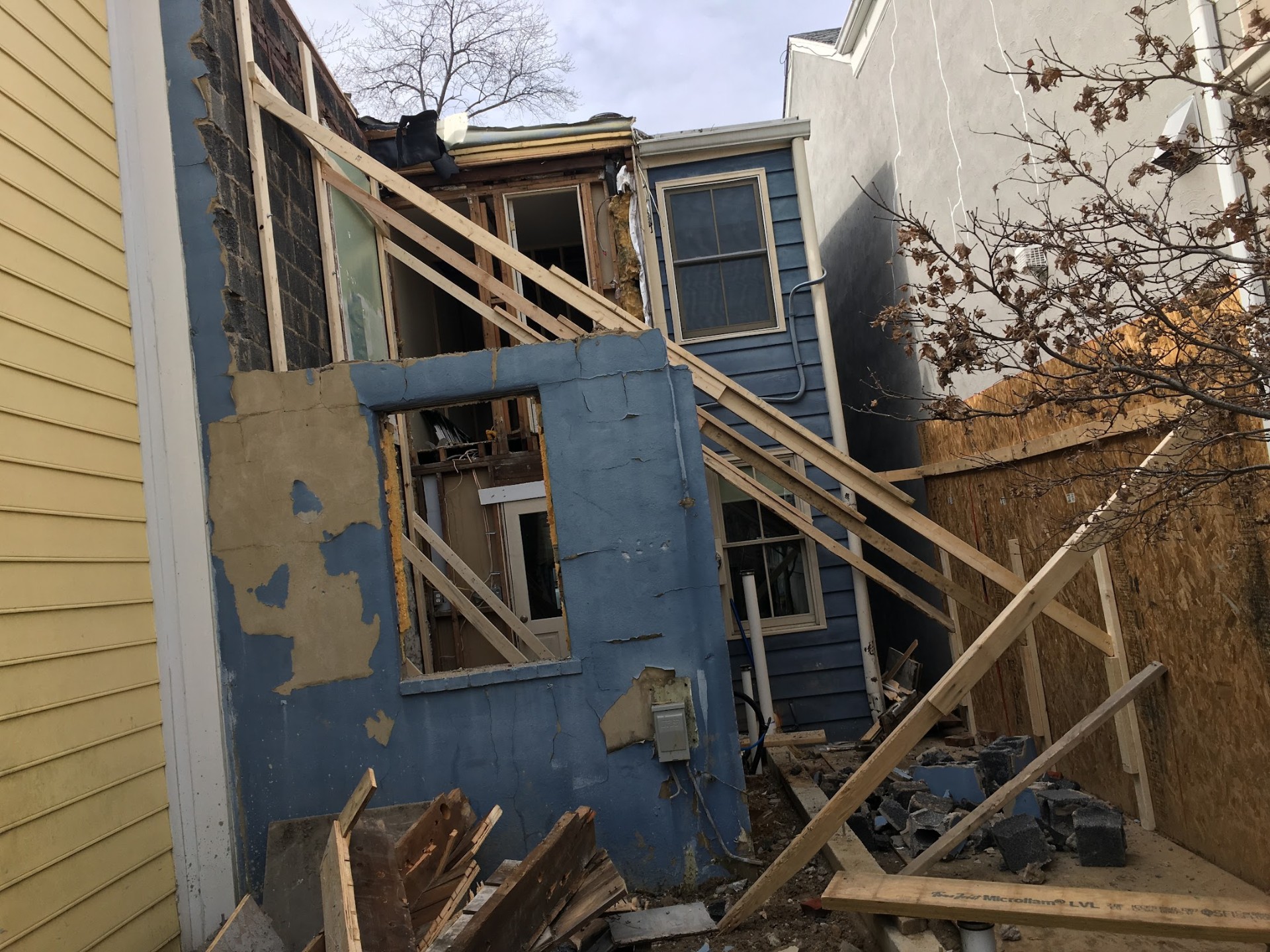 Rear of rowhome stripped to studs before full rebuild